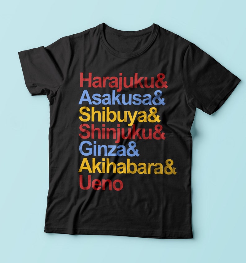May include: Black t-shirt with the text "Harajuku & Asakusa & Shibuya & Shinjuku & Ginza & Akihabara & Ueno" printed in red, blue, and yellow.