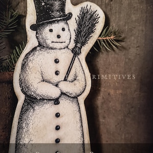 May include: A paper snowman pattern featuring a black and white illustration of a snowman wearing a top hat and holding a broom. The text on the image reads Paper Snowman Pattern 10 Inch PDF Instant Download. The design has a vintage aesthetic.
