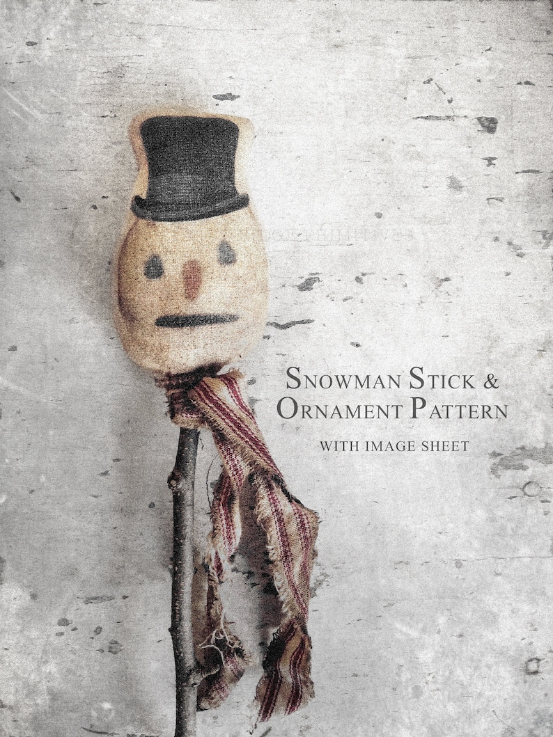 May include: A snowman stick and ornament pattern with image sheet. The snowman head is made of tan fabric with a black top hat, dark eyes, a small orange nose, and a black mouth. A frayed red and white striped scarf is tied around the stick.