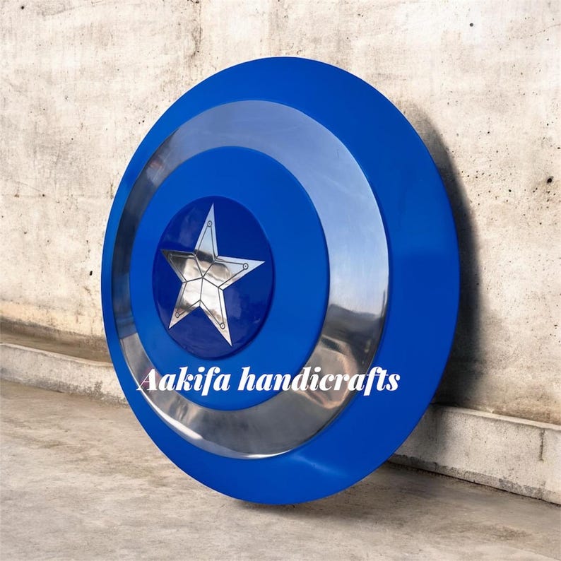 May include: A blue and silver shield with a central star design. The shield has concentric circles in blue and silver. The text "Aakifa handicrafts" is visible on the shield.