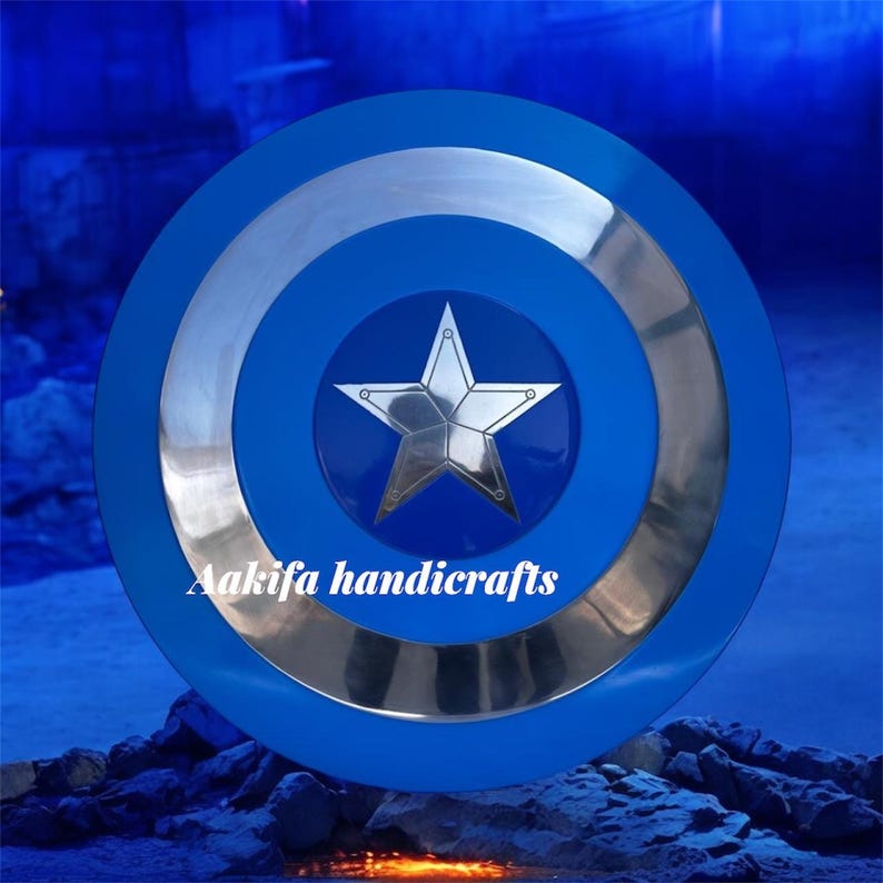 May include: A blue and silver shield featuring a central silver star design. The shield has concentric circles of blue and silver. The text "Aakifa handicrafts" is printed at the bottom of the shield.