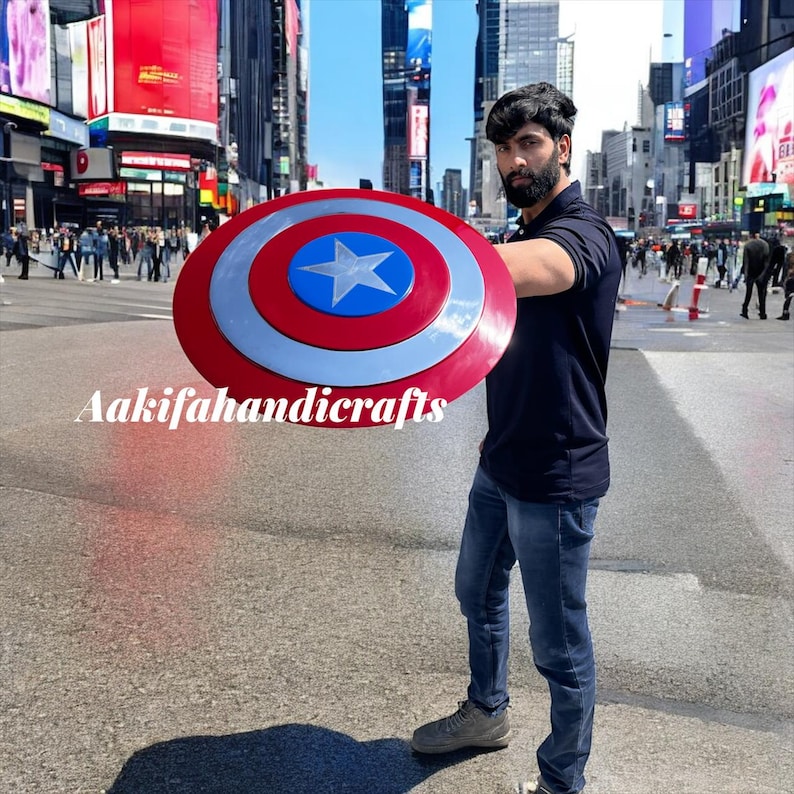 May include: A round shield in red, white, and blue, featuring a central star. The shield has a silver border and the text "Aakifahandicrafts".
