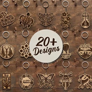 May include: A collection of laser-cut wooden keychains featuring various shapes including flowers, animals, butterflies, and geometric patterns. Each keychain has a metal ring. A central white circle displays the text 20+ Designs.