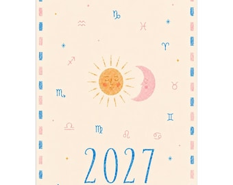 May include: A 2027 wall calendar with a cream background featuring a central yellow sun and pink crescent moon illustration. The design includes various blue and pink zodiac symbols scattered across the page, with the text 2027 WRITTEN IN THE STARS.
