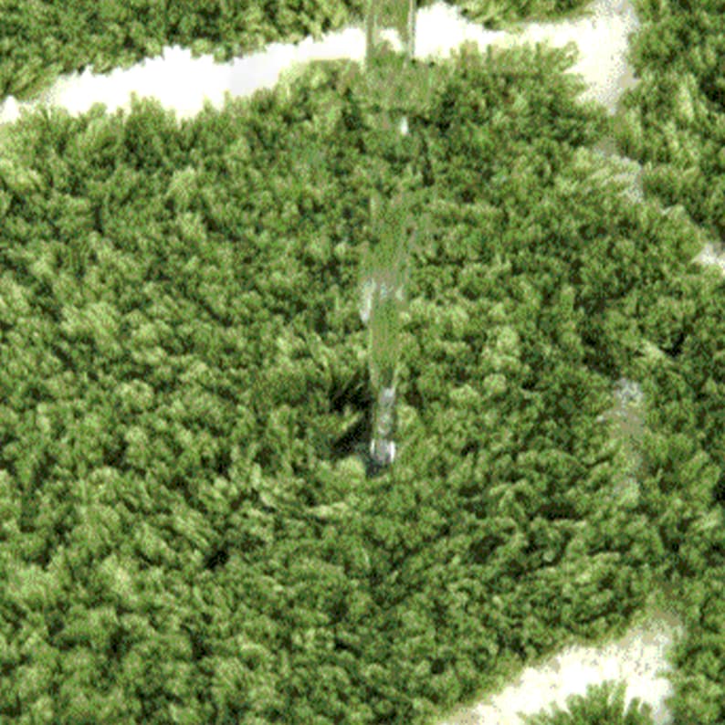 May include: Close-up of a green, shaggy rug with a white pattern. Water is being poured onto the rug, demonstrating its water-resistant properties. The rug has a dense, textured surface, and the water beads up on the fibers.