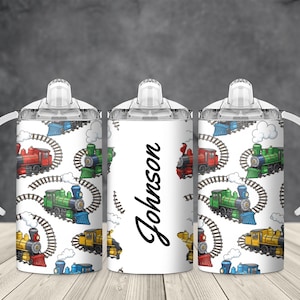 May include: Three white sippy cups with a train pattern. The pattern includes colorful cartoon trains on tracks, clouds, and a repeating design. The center cup has the name "Johnson" in black script.