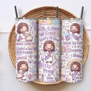 May include: Three cylindrical tumblers with black straws featuring a pastel purple and white pattern of cartoon figures, lambs, rainbows, and clouds. Text includes Faith, Hope, Grace, Glory to God, Jesus Loves You, Light in the Darkness, and Pray in Him.