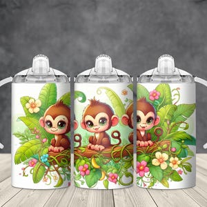 May include: Three white sippy cups with a jungle theme. Each cup features a brown monkey sitting on a log surrounded by green leaves, flowers, and vines. The cups have white handles and clear lids.