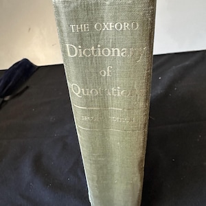 May include: A well-worn copy of "The Oxford Dictionary of Quotations" with a faded green cover. The spine features the title in white lettering, with "Second Edition" visible. The book shows signs of age and use, with a slightly distressed appearance.