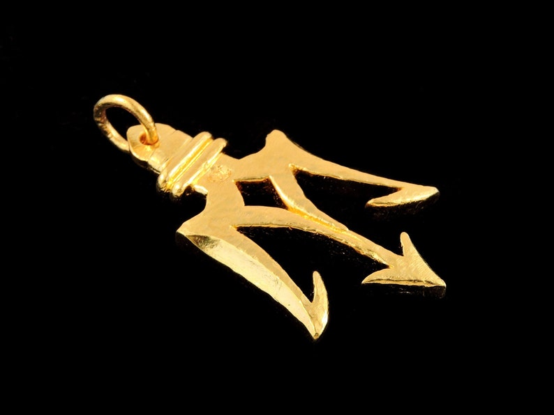 May include: A gold-colored trident pendant with a loop for attaching to a chain.