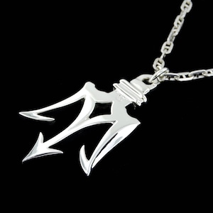 May include: Silver necklace with a trident pendant. The trident is a three-pronged spear, a symbol of power and strength.