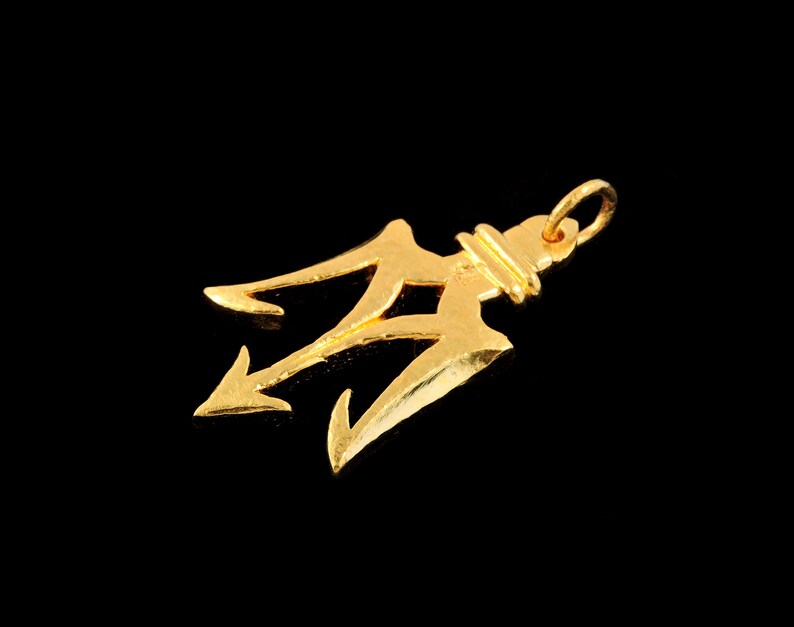 May include: A gold-colored trident pendant charm. The trident is a three-pronged spear, a symbol of power and strength.