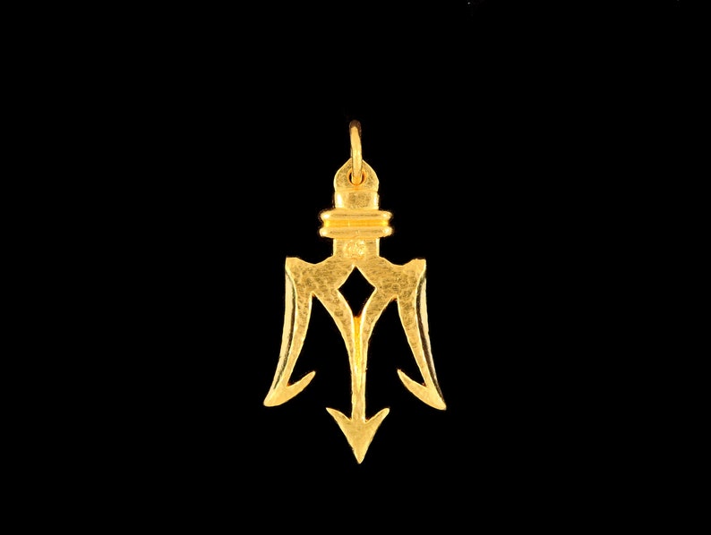 May include: A gold trident pendant with a textured surface. The pendant has a loop at the top for attaching to a chain.