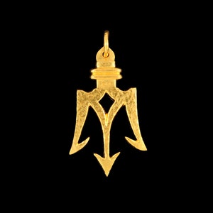 May include: A gold trident pendant with a textured surface. The pendant is a three-pronged spear with a ring at the top for attaching to a chain.