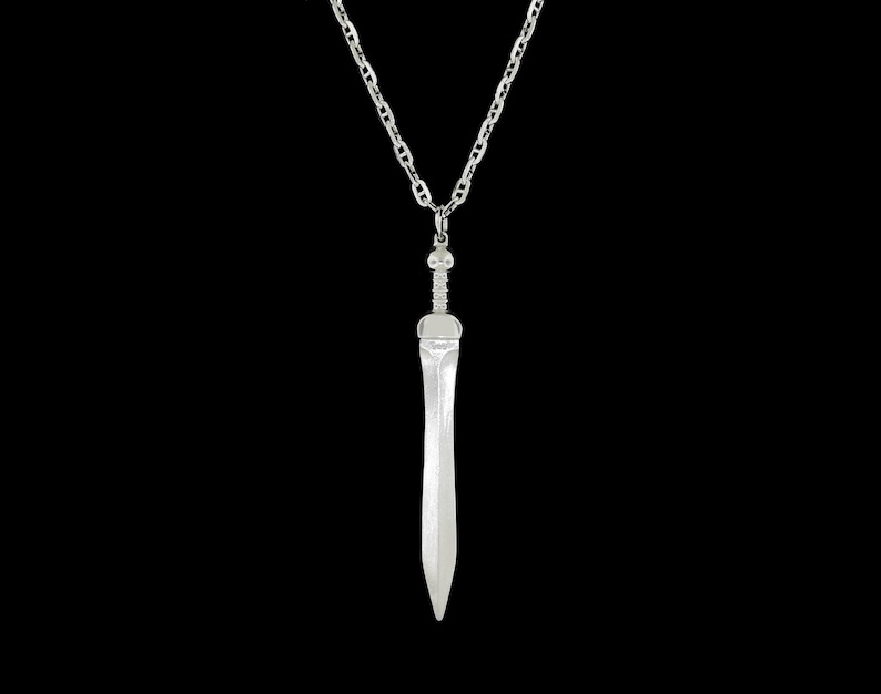 May include: A silver chain necklace with a silver sword pendant.
