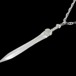 May include: A silver necklace with a sword pendant. The sword is detailed and has a sharp point.