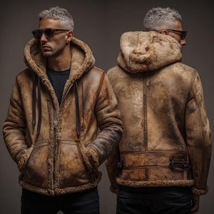 May include: A brown shearling-lined hooded jacket with a zip closure. The jacket features two front pockets and a drawstring hood. The jacket is worn by a person wearing sunglasses and a black shirt. The jacket is shown from the front and back.
