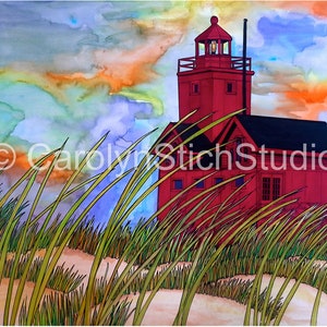 May include: A red lighthouse with a black roof stands tall against a colorful sunset sky. Tall green grass grows in the foreground, suggesting a coastal location.
