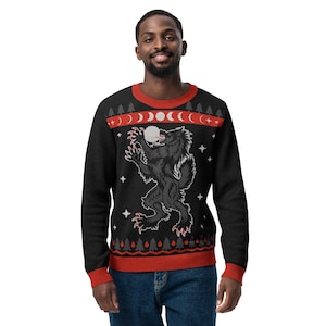 May include: Black sweater with a red and white pattern featuring a werewolf howling at the moon. The sweater has a festive holiday design.