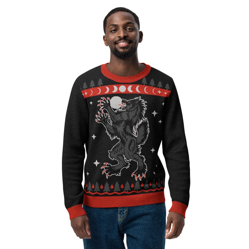 May include: Black sweater with a red and white pattern featuring a werewolf howling at the moon. The sweater has a festive holiday design.
