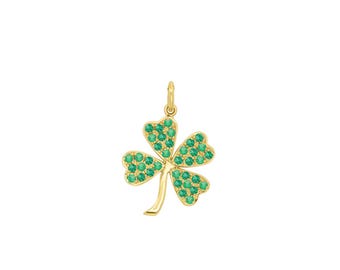 May include: A gold-colored shamrock pendant with four leaves. Each leaf is covered in small, round, green gemstones. The pendant has a small loop at the top for a chain. The shamrock is a symbol of luck and is often associated with St. Patrick's Day.