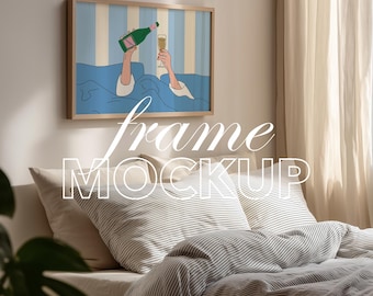 May include: A framed art print featuring a champagne bottle pouring into a glass, with a blue and white striped background. The frame is light brown, and the artwork is displayed above a bed with striped bedding. The image includes the text "frame MOCKUP".