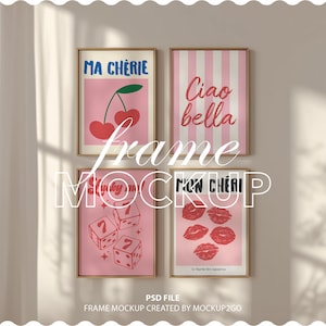 May include: Four framed art prints with gold frames are displayed on a wall. The prints feature pink backgrounds with various designs: cherries, vertical stripes, dice, and red lip prints. Text includes "MA CHERIE", "Ciao bella", and "MON CHERI".