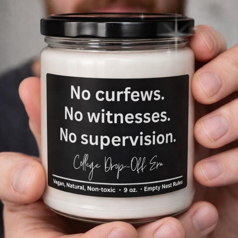 May include: A white candle in a glass jar with a black lid. The black label reads "No curfews. No witnesses. No supervision. College Drop-Off Era." The candle is 9 oz and is labeled as vegan, natural, and non-toxic.