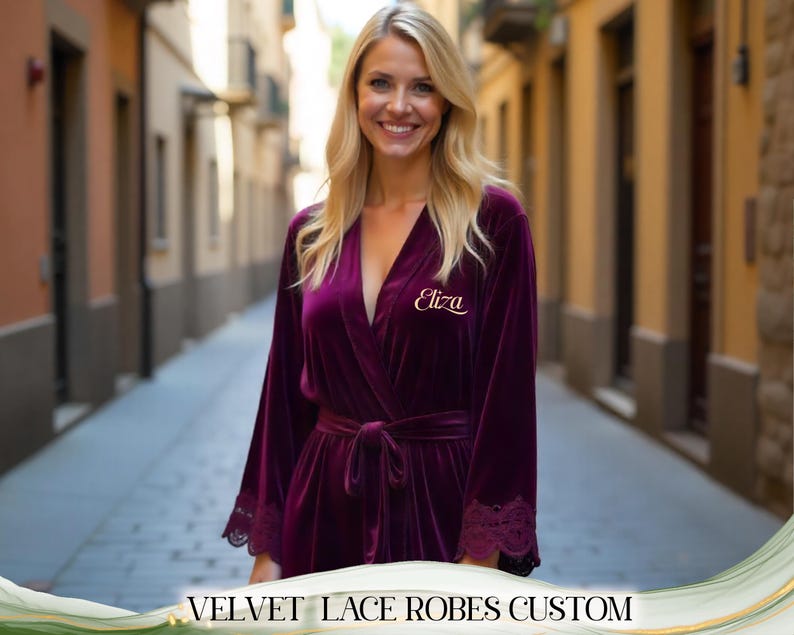 May include: A deep purple velvet robe with lace trim on the sleeves and a matching tie belt. The robe has the name "Eliza" embroidered in gold script on the chest. The text "VELVET LACE ROBES CUSTOM" is at the bottom of the image.