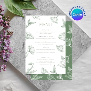 Puede incluir: Una tarjeta de menú con un diseño floral. El menú es blanco con ilustraciones florales verdes y texto. La palabra "MENU" está en la parte superior. La tarjeta está sobre una superficie gris, con flores moradas y blancas en el fondo. El texto "EDITABLE EN CANVA" está en un círculo en la esquina superior derecha.
