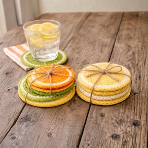 May include: A set of three ceramic mugs with a speckled, matte finish. The mugs are in shades of cream, light gray, and dark gray. Each mug has a simple, minimalist design and a rounded handle.