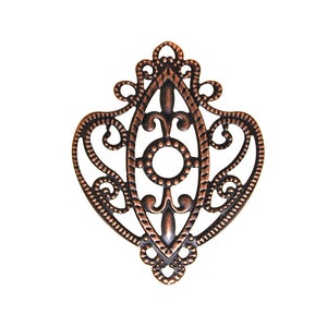 May include: A copper-colored metal pendant with a filigree design. The pendant is shaped like a heart with a decorative oval in the center.
