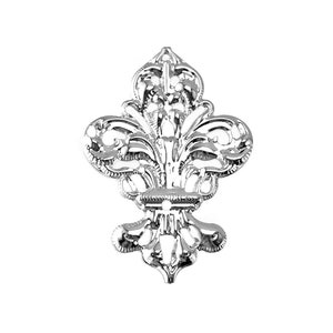 May include: A silver-toned decorative fleur-de-lis with intricate details. The design features a stylized flower with three petals and a central stem.
