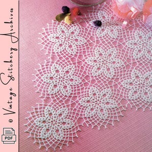 May include: A close-up of a white, crocheted doily with a floral pattern. The doily is on a pink surface. The image includes the text "Vintage Stitchery Archives" and a PDF icon.