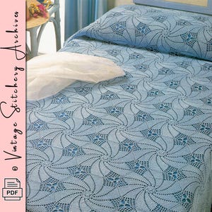 May include: A light blue crocheted bedspread and pillowcase set. The design features a repeating pattern of swirling floral motifs. The bedspread covers the bed and pillow, creating a cohesive and decorative look. The image also includes the text "Vintage Stitchery Archives" and a PDF icon.