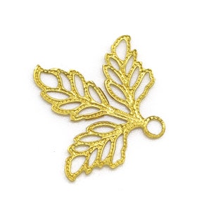 May include: Gold-toned metal leaf charm with a delicate, intricate design. The charm has a loop at the top for attaching to jewelry or other crafts.