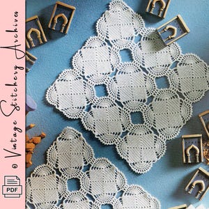 May include: Two white, crocheted doilies with a geometric design are displayed on a blue surface. The doilies have a square shape with openwork centers and decorative edges. Small, decorative wooden arches are scattered around the doilies. The text "Vintage Stitchery Archives" is visible.