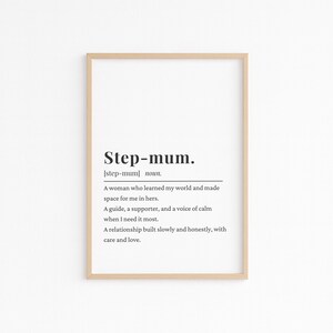 May include: A framed print featuring the definition of "Step-mum." The text is in black on a white background, enclosed in a light brown wooden frame. The definition describes a step-mum as a guide, supporter, and a voice of calm.