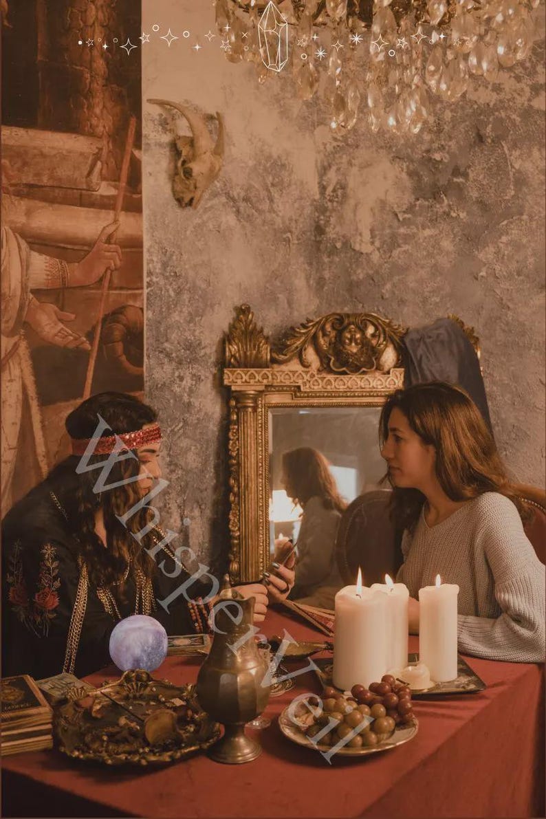 May include: An atmospheric image of two people seated at a table draped in red, engaged in a mystical setting. The scene includes candles, a decorative mirror, and a brass vessel. The word "Whisperveil" is partially visible.