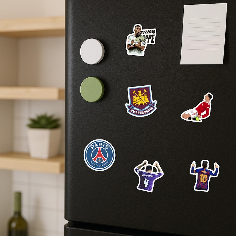May include: A collection of colorful stickers featuring soccer players and team logos. Includes a Paris Saint-Germain logo, a West Ham United crest, and images of Kylian Mbapp&eacute; and Lionel Messi.