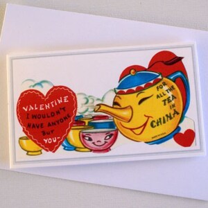 May include: A vintage Valentine's Day card with a smiling yellow teapot wearing a blue and red hat, and the text "FOR ALL THE TEA IN CHINA." A red heart with the text "VALENTINE I WOULDN'T HAVE ANYONE BUT YOU" is also present.
