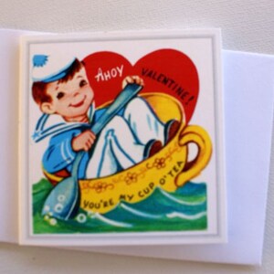 May include: A vintage Valentine's Day card with a cartoon sailor in a teacup. The card reads "Ahoy Valentine! You're my cup o' tea." The sailor is in a blue and white uniform, and the teacup is yellow with a red heart.