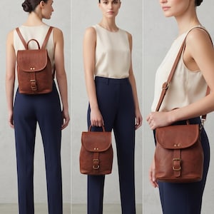 May include: A cognac brown leather backpack featuring a top handle, a fold-over flap with two gold-tone rivets, and a central buckle closure. The bag includes adjustable shoulder straps that allow it to be worn as a backpack or a shoulder bag.