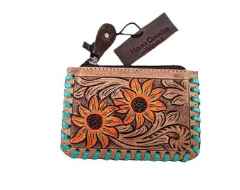 May include: Tan leather coin purse with a sunflower design in orange and brown. The purse has turquoise stitching around the edges and a zipper closure. A tag that says "Maya's Curiosities" is attached.