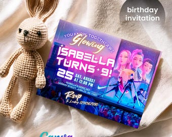 May include: A crocheted beige bunny toy next to a birthday invitation. The invitation reads "Isabella Turns 25 + 9!" with event details. The invitation has a colorful design with illustrations of animated characters and the text "You Know Together We Glowing."