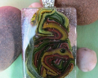 Monkey Man Fused Glass Pendant in khaki, lime, and gold green with burnt red accents.