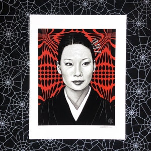May include: A black and white illustration of a woman with dark hair and a red and black geometric background. The woman is wearing a black kimono with a white collar.