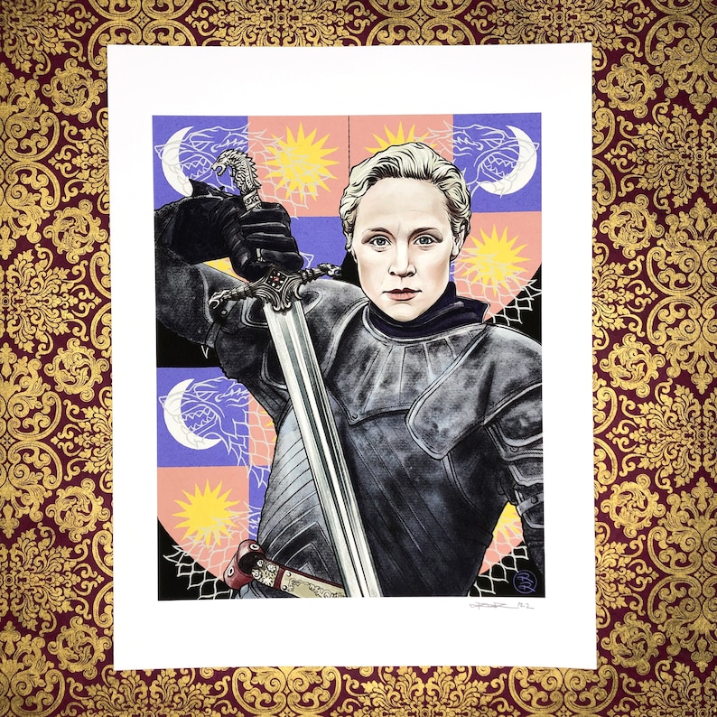 May include: A woman in black armor holds a sword with a silver blade. She is standing in front of a colorful background with a pattern of stars and moons. The background is a shield with a design of a wolf, a star, and a moon.