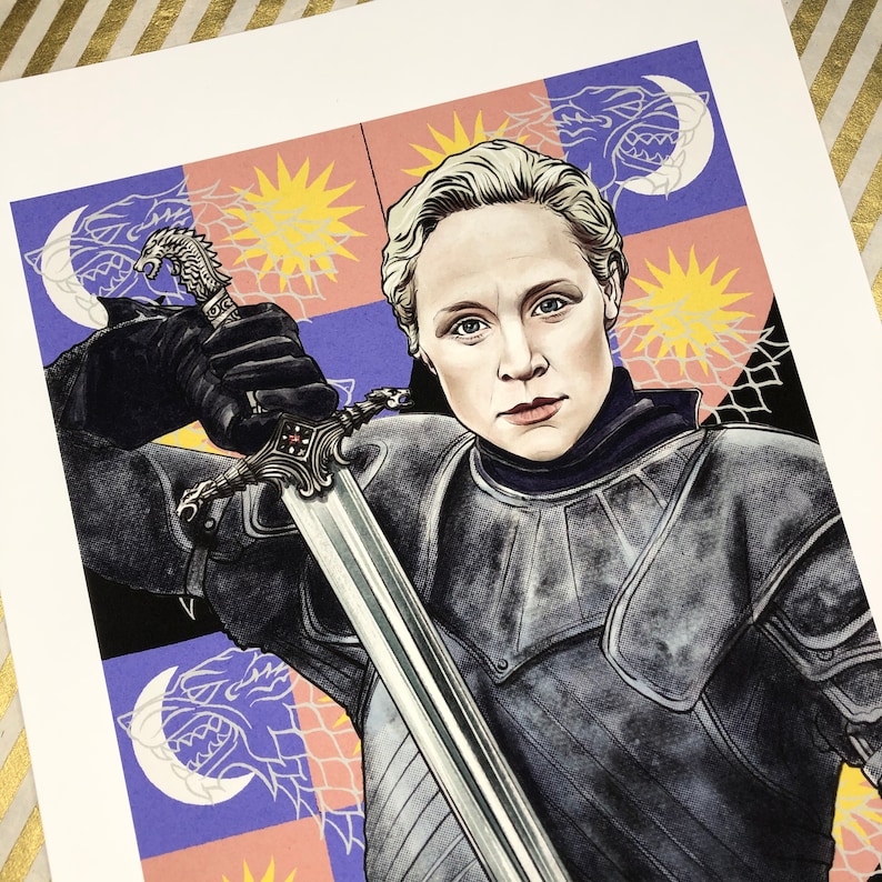 May include: A woman in silver armor holds a sword, standing in front of a colorful background with a repeating pattern of wolves and suns.