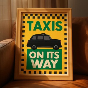May include: Framed art print featuring a black taxi cab illustration on a yellow and green background. The words "TAXIS" and "ON ITS WAY" are displayed in bold, white and green text. The frame is a light brown color.